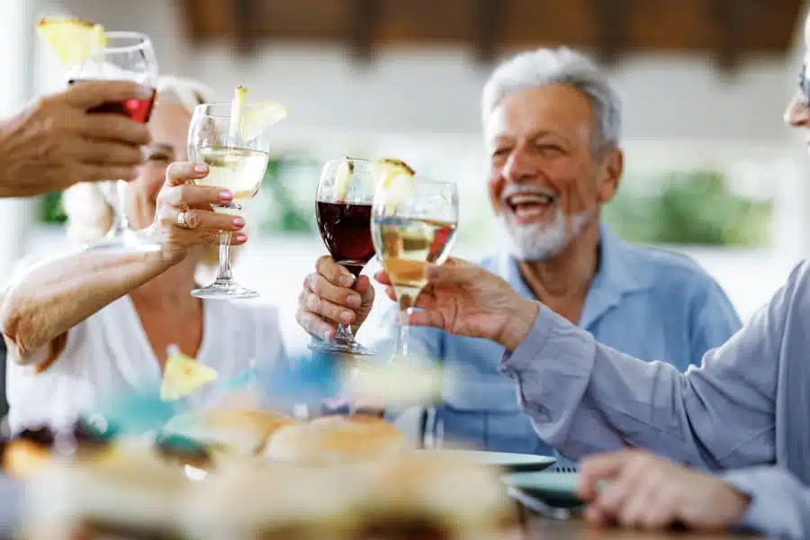 Group of seniors drinking and toasting cocktails