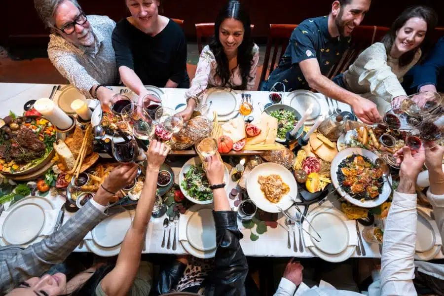 Overhead view of friends enjoying luxury meal at restaurant